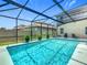 A screened in pool with clear, blue water and multiple potted plants at 209 Willow Bend Dr, Davenport, FL 33897