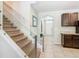 Bright staircase with glass railings and carpeted steps leading to the upper level at 209 Willow Bend Dr, Davenport, FL 33897