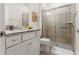 Modern bathroom featuring a granite countertop vanity and a glass-enclosed tiled shower at 2161 Lelani Cir, Davenport, FL 33897