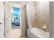 Hallway view showcasing a bathroom with shower, extending to a whimsical bedroom at 2161 Lelani Cir, Davenport, FL 33897