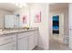 Well-lit bathroom featuring granite countertops, white cabinets, and princess-themed artwork at 2161 Lelani Cir, Davenport, FL 33897