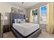 Bright bedroom with natural light, featuring a decorative bed, stylish lamps, and modern artwork at 2161 Lelani Cir, Davenport, FL 33897