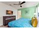 Cozy bedroom featuring a comfortable bed, stylish dresser with a TV, and a calming color scheme for relaxation at 2161 Lelani Cir, Davenport, FL 33897