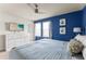 Bright bedroom features a ceiling fan, TV and beach-themed artwork at 2161 Lelani Cir, Davenport, FL 33897
