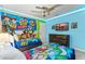 Fun themed bedroom with twin beds, colorful artwork, and playful decor, perfect for or 'Toy Story' fans at 2161 Lelani Cir, Davenport, FL 33897