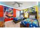 Bright, themed bedroom featuring two twin beds, colorful artwork, and playful decor, perfect for or 'Toy Story' fans at 2161 Lelani Cir, Davenport, FL 33897