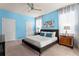 Vibrant bedroom with blue walls, featuring matching nightstands and decorative artwork, creating a tranquil atmosphere at 2161 Lelani Cir, Davenport, FL 33897