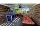 Private cabana with comfortable seating, a TV, and a view of the pool and surrounding landscape at 2161 Lelani Cir, Davenport, FL 33897