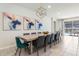 Elegant dining room with a large table, modern art, and access to the pool area at 2161 Lelani Cir, Davenport, FL 33897