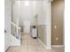 Bright entryway with high ceilings, neutral tones, tile flooring, and a staircase at 2161 Lelani Cir, Davenport, FL 33897