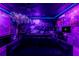Eclectic game room with custom murals, a pool table, foosball, and comfortable seating, illuminated with colorful lights at 2161 Lelani Cir, Davenport, FL 33897