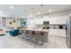 Modern kitchen featuring white cabinetry, stainless appliances, and a breakfast bar at 2161 Lelani Cir, Davenport, FL 33897