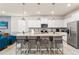 Stylish kitchen with an island bar, granite countertops, and stainless steel appliances at 2161 Lelani Cir, Davenport, FL 33897