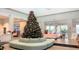 Festive lobby with a grand Christmas tree, comfortable seating, and a welcoming atmosphere at 2161 Lelani Cir, Davenport, FL 33897