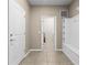 Well-lit mud room featuring tile floors, built-in storage, and an open doorway at 2161 Lelani Cir, Davenport, FL 33897