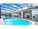 Beautiful screened-in pool with hot tub and covered patio, perfect for outdoor entertaining and relaxation at 2161 Lelani Cir, Davenport, FL 33897