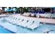 Inviting zero entry pool featuring in-water loungers and surrounding patio seating at 2161 Lelani Cir, Davenport, FL 33897