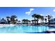 Large community pool with inviting turquoise water, surrounded by palm trees and lounge chairs for ultimate relaxation at 2161 Lelani Cir, Davenport, FL 33897