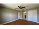 Bedroom showing doorway to bathroom, closet with bi-fold doors, and ceiling fan at 2326 St Marteen Ct, Kissimmee, FL 34741