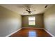This bedroom includes a ceiling fan, a window and tile floors at 2326 St Marteen Ct, Kissimmee, FL 34741
