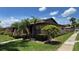 Well-kept single-story home featuring a neatly manicured lawn and palm trees at 2326 St Marteen Ct, Kissimmee, FL 34741