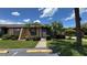 Inviting single-story home with a tidy front lawn and tropical landscaping at 2326 St Marteen Ct, Kissimmee, FL 34741