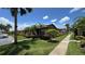 Well-kept single-story home with manicured lawn and tropical trees at 2326 St Marteen Ct, Kissimmee, FL 34741