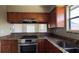 Well-equipped kitchen with stylish countertops, stainless steel range, and convenient breakfast bar at 2326 St Marteen Ct, Kissimmee, FL 34741