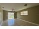 Living room with view into back yard through sliding glass door at 2326 St Marteen Ct, Kissimmee, FL 34741