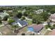 Picture of a blue house with a fenced yard surrounded by mature trees in a residential neighborhood at 238 Sunridge Woods Blvd, Davenport, FL 33837