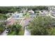 An aerial view showcases a vibrant neighborhood featuring well-maintained homes, some with screened-in pools, surrounded by lush greenery at 238 Sunridge Woods Blvd, Davenport, FL 33837