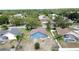 Backyard view of a blue single-Gathering home with mature trees and a lawn in a suburban neighborhood at 238 Sunridge Woods Blvd, Davenport, FL 33837