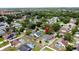 Wide aerial view of a neighborhood with many mature trees and a marker near a blue home at 238 Sunridge Woods Blvd, Davenport, FL 33837