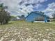 Spacious backyard with lush grass, a fire pit, and tasteful landscaping, perfect for relaxation at 238 Sunridge Woods Blvd, Davenport, FL 33837