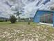Lush backyard with a fire pit and mature trees, offers privacy and room for outdoor entertaining at 238 Sunridge Woods Blvd, Davenport, FL 33837