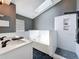 Modern bathroom with a skylight, stylish subway tile shower, and a deep soaking tub perfect for relaxation at 238 Sunridge Woods Blvd, Davenport, FL 33837