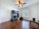 Bright bedroom with a ceiling fan, hardwood floors, and large window offering natural light and comfortable living space at 238 Sunridge Woods Blvd, Davenport, FL 33837