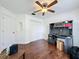 Bedroom featuring hardwood floors, a ceiling fan, large closet, and a modern desk area, perfect for work at 238 Sunridge Woods Blvd, Davenport, FL 33837