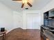 Bedroom showcasing hardwood floors, a ceiling fan, ample closet space, and a built-in desk area at 238 Sunridge Woods Blvd, Davenport, FL 33837