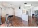Spacious open floorplan with hardwood floors, dining area, and open kitchen at 238 Sunridge Woods Blvd, Davenport, FL 33837