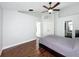 Main bedroom featuring wood flooring, ceiling fan, and ensuite bathroom access at 238 Sunridge Woods Blvd, Davenport, FL 33837