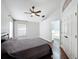 Spacious main bedroom with wood flooring, ensuite bath, ceiling fan, and natural light at 238 Sunridge Woods Blvd, Davenport, FL 33837