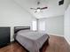 Cozy main bedroom featuring wood flooring, a ceiling fan, and natural lighting at 238 Sunridge Woods Blvd, Davenport, FL 33837