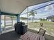 Screened-in patio with a grill and seating offers a relaxing view of the landscaped backyard at 238 Sunridge Woods Blvd, Davenport, FL 33837