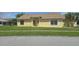 Single-story home with a well-maintained lawn, and a simple landscape design at 2401 Cedarfield Ln, Kissimmee, FL 34744