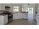 Modern kitchen features white cabinets, sleek appliances, and an open layout at 2401 Cedarfield Ln, Kissimmee, FL 34744