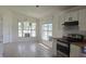 Bright kitchen features white cabinets, a modern oven, and large windows that bring in ample light at 2401 Cedarfield Ln, Kissimmee, FL 34744