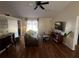 Open living room with hardwood floors, modern ceiling fan, and lots of natural light at 2704 Kendall Ave, Kissimmee, FL 34744