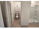Bathroom featuring an enclosed shower, toilet and cabinets at 2722 Numa Falls Ave, Davenport, FL 33837