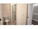 Bright bathroom featuring a toilet and shower with glass doors, offering a fresh and modern bathing experience at 2722 Numa Falls Ave, Davenport, FL 33837